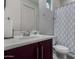 Clean bathroom with new fixtures, a granite countertop, and a decorative mirror at 21602 N 36Th St, Phoenix, AZ 85050