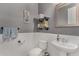 A charming bathroom featuring wainscoting, gray walls, decorative shelves, and a pedestal sink at 21602 N 36Th St, Phoenix, AZ 85050