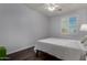 Bright bedroom with a ceiling fan and a window with shutter-style blinds at 21602 N 36Th St, Phoenix, AZ 85050