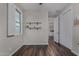 Light and airy bedroom featuring dark floors, a window with blinds, closet and built in shelving at 21602 N 36Th St, Phoenix, AZ 85050