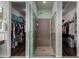 Walk-in closet with organized shelving, hanging rods, and a glass-enclosed shower nearby at 21602 N 36Th St, Phoenix, AZ 85050