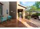 Inviting courtyard with a colorful table set, lush greenery, and a textured concrete patio at 21602 N 36Th St, Phoenix, AZ 85050