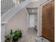 Inviting foyer with curved staircase, tiled floor, and wood door at 21602 N 36Th St, Phoenix, AZ 85050