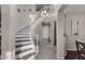 Grand foyer showcases a sweeping staircase, chandelier, and wood-look floors at 21602 N 36Th St, Phoenix, AZ 85050