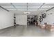 Spacious garage featuring epoxy flooring, overhead storage, and ample space for vehicles and storage at 21602 N 36Th St, Phoenix, AZ 85050