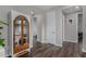 Neutral hallway with wood floors, decorative cabinet with glass doors and views into multiple rooms at 21602 N 36Th St, Phoenix, AZ 85050