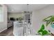Bright hallway with white railings, dark wood floors, and a view of the living area and lush green plants at 21602 N 36Th St, Phoenix, AZ 85050