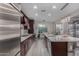 A spacious kitchen featuring stainless steel appliances, dark cabinets, and a central island with counter seating at 21602 N 36Th St, Phoenix, AZ 85050