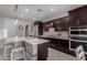 A stylish kitchen boasts dark wood cabinetry, stainless appliances, a large island with seating, and quartz countertops at 21602 N 36Th St, Phoenix, AZ 85050