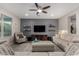 Cozy living room with sofa, arm chair, media center and recessed lighting at 21602 N 36Th St, Phoenix, AZ 85050