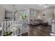 Inviting living area with dark wood floors, light gray sofa, and plenty of natural light from multiple windows at 21602 N 36Th St, Phoenix, AZ 85050