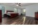 Spacious main bedroom with hardwood floors, plantation shutters, ceiling fan, and attached office space at 21602 N 36Th St, Phoenix, AZ 85050