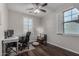 Bright office space with two windows, dark floors, a modern desk, and comfortable seating at 21602 N 36Th St, Phoenix, AZ 85050
