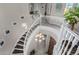 Grand curved staircase with white banister, wood stairs, and ornate chandelier at entry at 21602 N 36Th St, Phoenix, AZ 85050