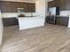 Modern kitchen features stainless steel appliances, a center island, and dark brown cabinets at 22368 W Monona Ln, Surprise, AZ 85387