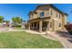 Expansive backyard with a covered patio, grassy area, and access to the pool at 2257 E Redwood Ct, Chandler, AZ 85286