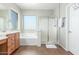 Clean bathroom features a vanity with sink, a separate bathtub and shower, and natural light at 2257 E Redwood Ct, Chandler, AZ 85286