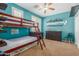 Vibrant bedroom featuring a bunk bed, a dresser, and colorful decor against a turquoise wall at 2257 E Redwood Ct, Chandler, AZ 85286