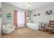 bedroom with soft carpet, a rocking chair, whimsical decor, and a small twin bed at 2257 E Redwood Ct, Chandler, AZ 85286
