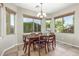 Formal dining room with wood table, six chairs, and natural light at 2257 E Redwood Ct, Chandler, AZ 85286