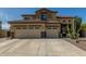 Inviting two-story home featuring a spacious three-car garage and desert landscaping at 2257 E Redwood Ct, Chandler, AZ 85286