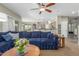 Inviting living room with plush blue sofa, ceiling fan, and neutral walls at 2257 E Redwood Ct, Chandler, AZ 85286