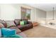 Open living space with a leather sectional, carpeted floor, and natural light at 2257 E Redwood Ct, Chandler, AZ 85286