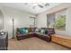 Comfortable living room with a large leather sectional and natural light at 2257 E Redwood Ct, Chandler, AZ 85286