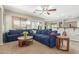 Inviting living room with plush blue sofa, ceiling fan, and neutral walls at 2257 E Redwood Ct, Chandler, AZ 85286