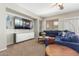 Comfortable living room with large television and plush blue seating at 2257 E Redwood Ct, Chandler, AZ 85286