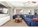 Comfortable living room with large television and plush blue seating at 2257 E Redwood Ct, Chandler, AZ 85286