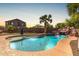 Beautiful backyard pool with a rock waterfall feature and lush landscaping at 2257 E Redwood Ct, Chandler, AZ 85286