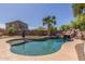 Backyard pool featuring a rock waterfall, surrounded by lush landscaping at 2257 E Redwood Ct, Chandler, AZ 85286