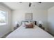 Bedroom features a bed with decorative pillows, lamps, and a large window for natural light at 2338 E Folley St, Chandler, AZ 85225