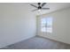 Bright bedroom featuring a ceiling fan, neutral carpet, and a window with a view at 2338 E Folley St, Chandler, AZ 85225