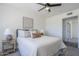 The bedroom has a light color palette and a bed with decorative pillows and lamps at 2338 E Folley St, Chandler, AZ 85225