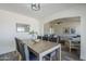 Bright dining room featuring a modern light fixture and a view into the adjacent living space at 2338 E Folley St, Chandler, AZ 85225