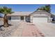 Single story home featuring neutral stucco exterior, desert landscaping and a two-car garage at 2338 E Folley St, Chandler, AZ 85225