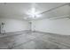 Spacious garage with concrete floor, white walls, and a white garage door at 2338 E Folley St, Chandler, AZ 85225