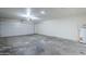 Spacious garage with concrete floor, white walls, and a white garage door at 2338 E Folley St, Chandler, AZ 85225