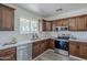 Charming kitchen features warm wood cabinetry, stainless steel appliances, and bright white subway tile backsplash at 2338 E Folley St, Chandler, AZ 85225