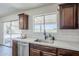This modern kitchen sink features stainless steel appliances, dark wood cabinetry, and bright white subway tile at 2338 E Folley St, Chandler, AZ 85225