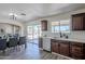 Open kitchen and dining area with backyard views, stainless steel appliances, and dark wood cabinets at 2338 E Folley St, Chandler, AZ 85225