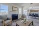 Bright living room featuring a fireplace, neutral walls, and wood-look flooring at 2338 E Folley St, Chandler, AZ 85225