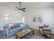 Inviting living room featuring neutral paint, vaulted ceiling, ceiling fan and gray wood-look floors at 2338 E Folley St, Chandler, AZ 85225
