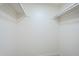 Walk-in closet with white walls and baseboards, as well as clothes racks at 2338 E Folley St, Chandler, AZ 85225
