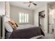 Cozy bedroom with carpeted floors, a ceiling fan, a window with shutters, and a closet at 25875 S 227Th Way, Queen Creek, AZ 85142
