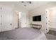 Bright bedroom featuring a ceiling fan, a wall-mounted television, and ensuite bathroom for comfort at 25875 S 227Th Way, Queen Creek, AZ 85142