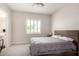 Cozy bedroom with carpeted floors, a ceiling fan, a window with shutters, and an ensuite bathroom with vanity at 25875 S 227Th Way, Queen Creek, AZ 85142