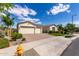 Single-story home with a spacious three-car garage, desert landscaping, and a brick-paved driveway and front entryway at 25875 S 227Th Way, Queen Creek, AZ 85142